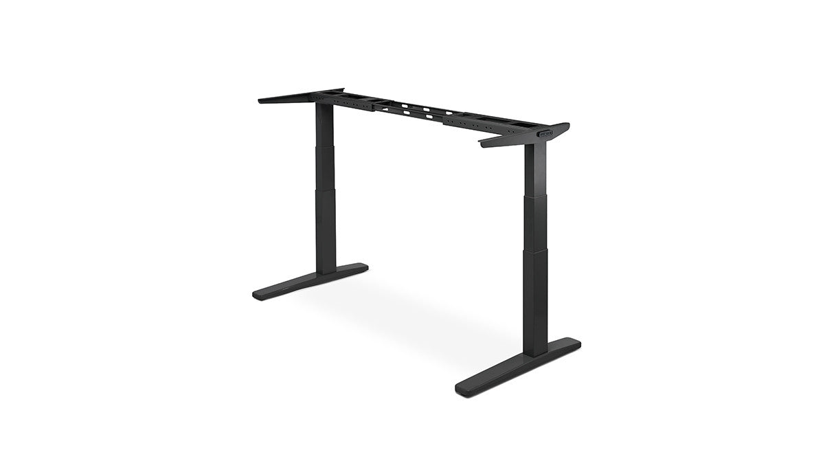 Uplift V3 standing desk — black frame three-quarter view at standing height