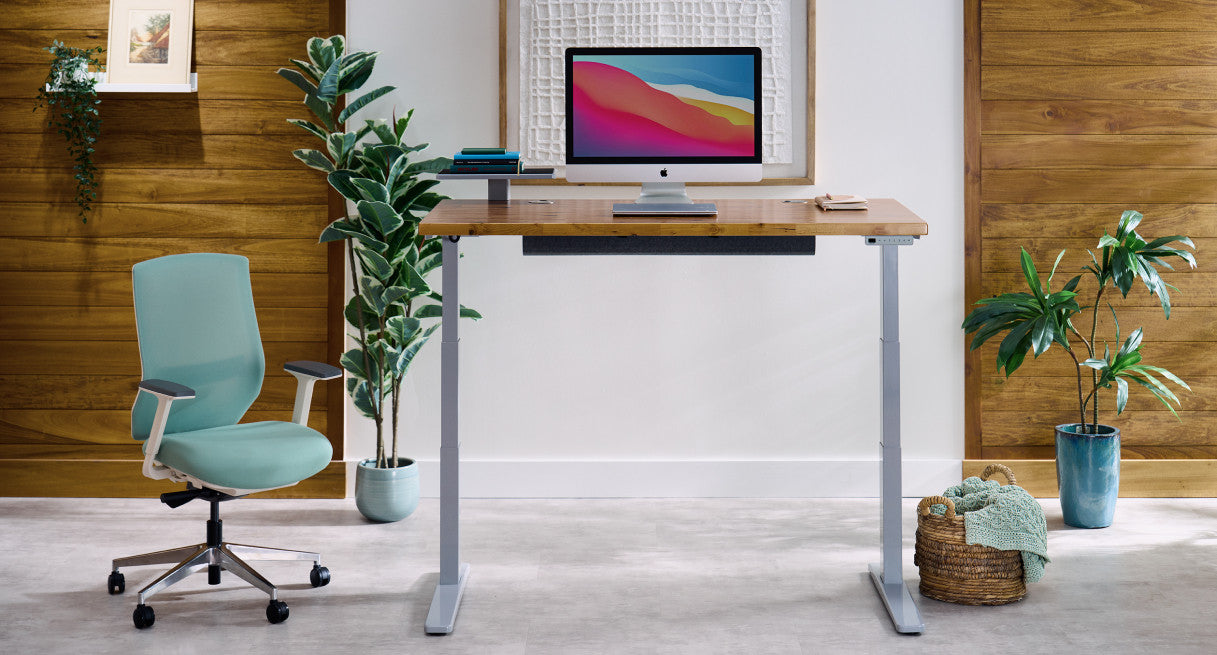 Uplift V3 standing desk — gray frame in professional home office setup